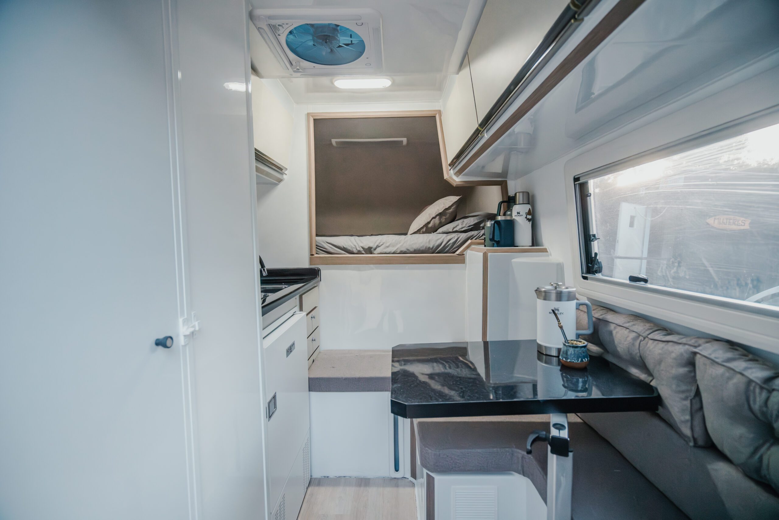4. 180 Sur Campers Rental - Duaron Zion camper 4x4 - interior - bed -kitchen- table area