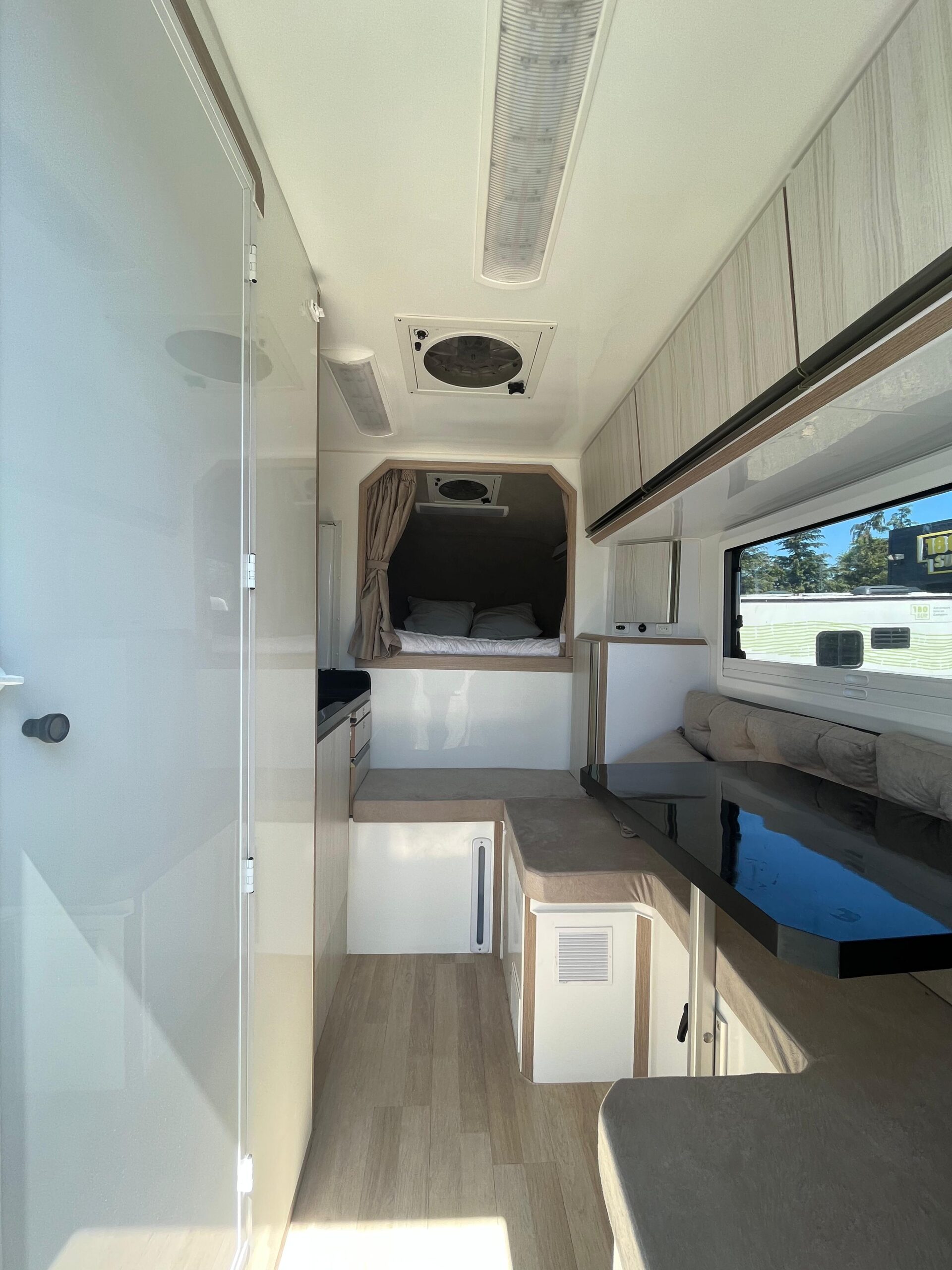 8. 180 Sur Campers Rental - Duaron Roam camper 4x4 - interior - kitchen - bed - table