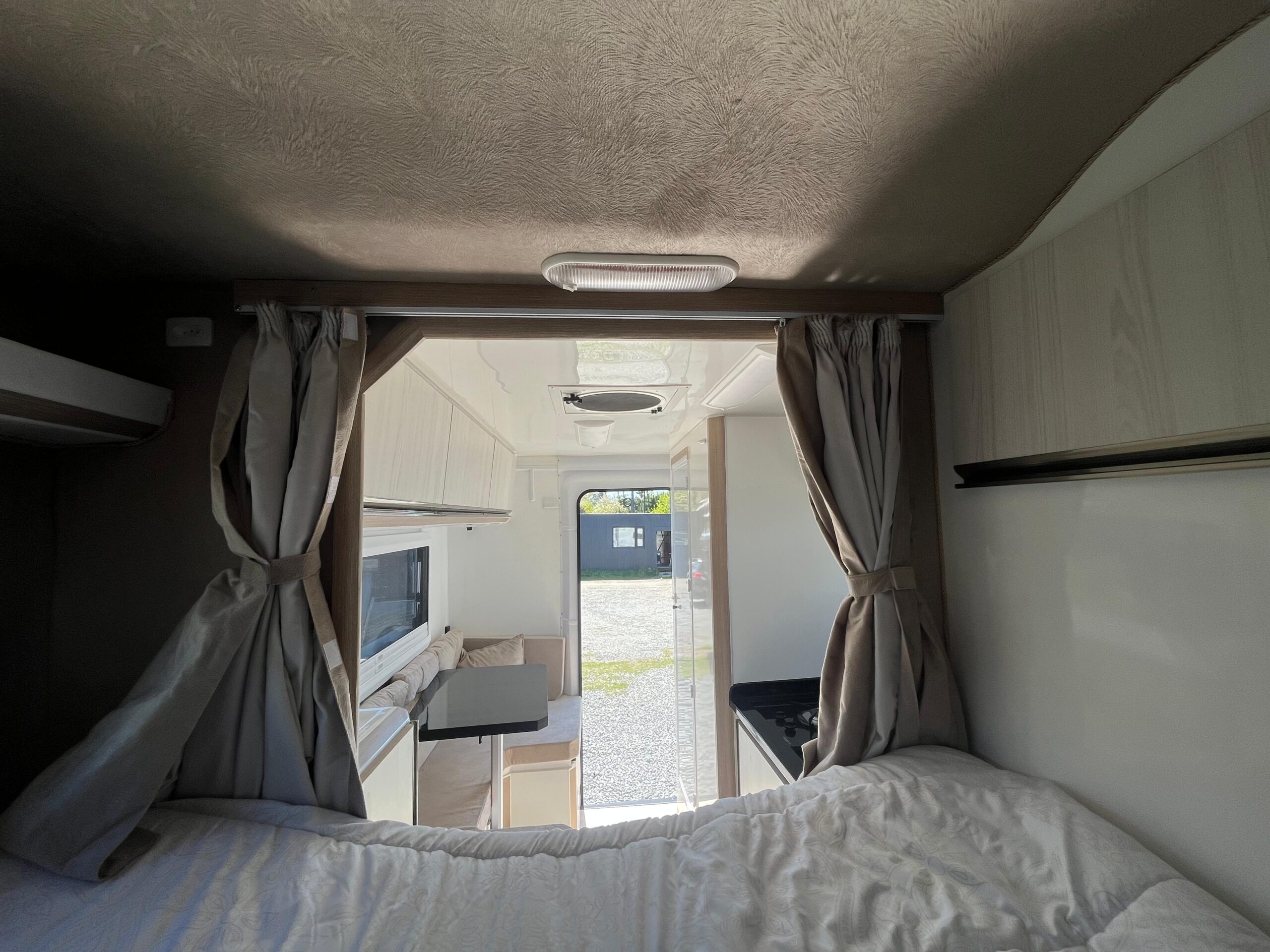 9. 180 Sur Campers Rental - Duaron Roam- king camper 4x4 - interior - bed view